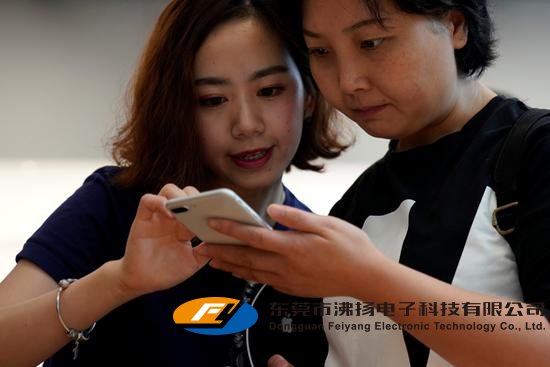 A staff member, left, explains Apple's new iPhone 8 Plus after it goes on sale at an Apple Store in Shanghai, China, Sept. 22.